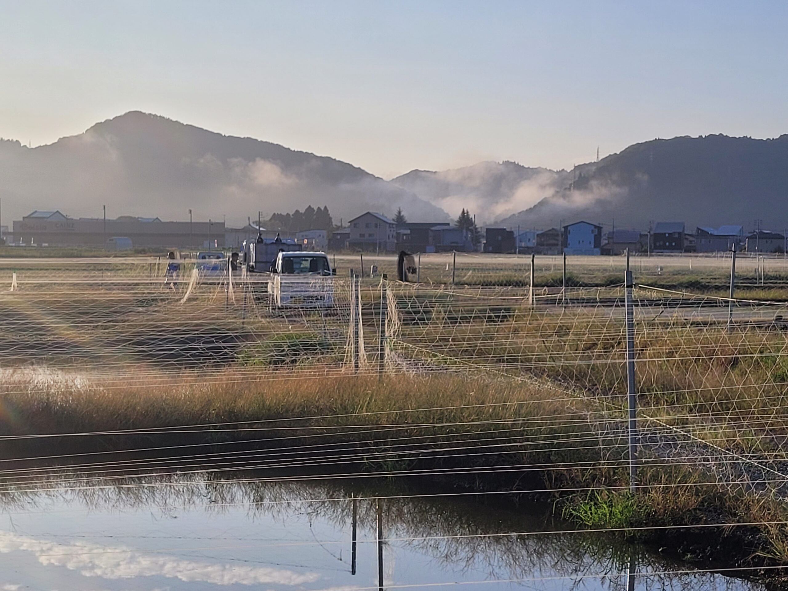 Berge im Morgennebel über flachen Teichen